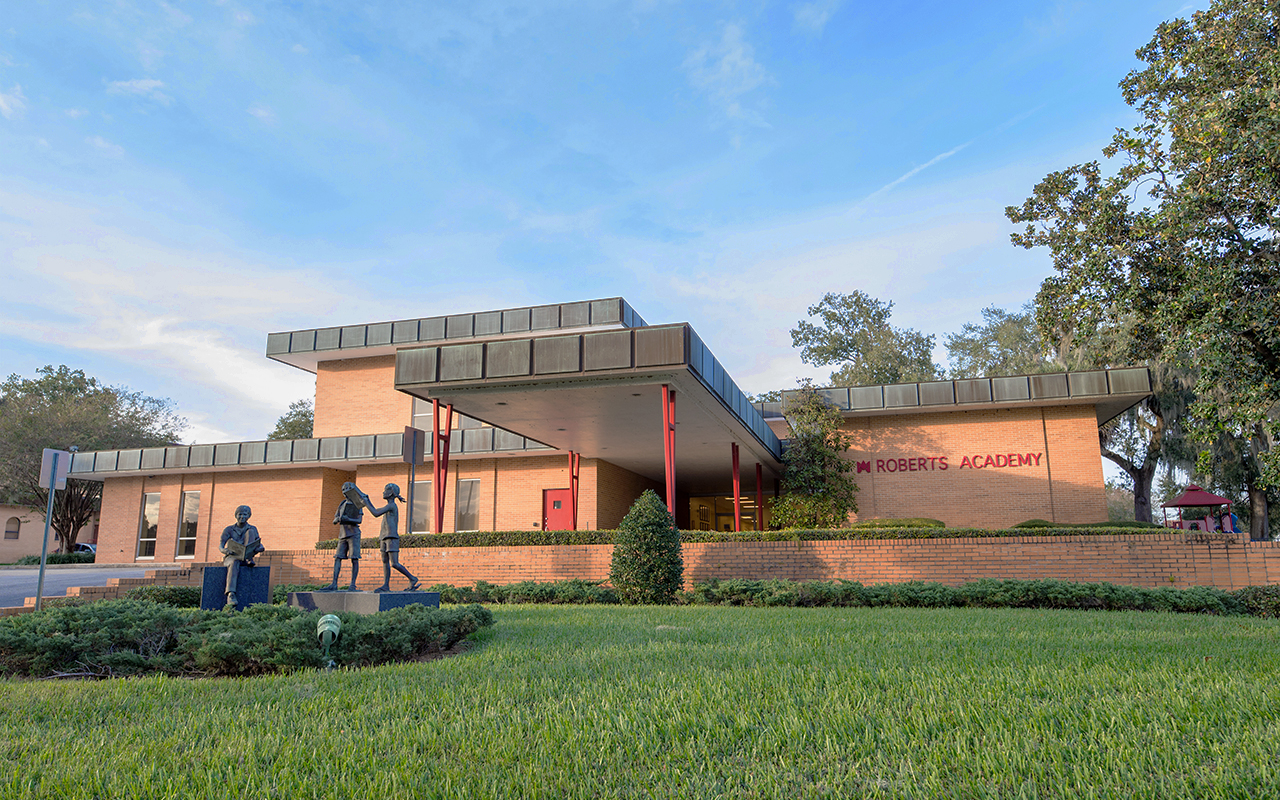 Exterior photo of the Roberts Academy building with a clear blue sky.