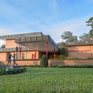 Exterior photo of the Roberts Academy building with a clear blue sky.